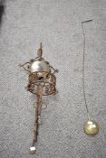 An iron folk art style wall sconce, h82cm, sold together with a clock pendulum, (2)