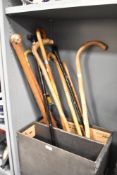 An adjustable fold away metal walking stick, h86cm, sold together with 8 wooden canes and an