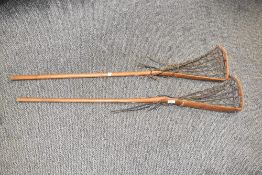 A pair of early 20th century Hattersleys & Son style wooden lacrosse sticks, L110cm