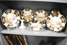 An Aynsley cabinet plate, decorated with a blue and gold border, having a central hand painted