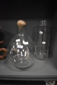 A clear glass display vase with stopper, h35cm, sold together with a cylindrical glass vase, (2)