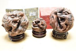 A set of 3 Chinese Zodiac Horoscope Astrology carved dragon balls on circular stands, largest w9cm