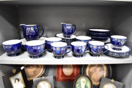 A Denby part dinner service, decorated with floral patterns on a colbalt ground, to include cups and