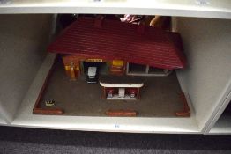 A wooden home made toy garage with fuel pumps
