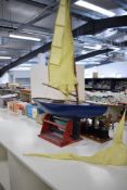 A wooden Pond Yacht with sail and on metal stand, length 95cm, height approx 145cm, very well made