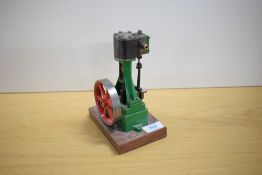 A Stuart Turner live steam model of a vertical cylinder engine, the cast iron frame finished in