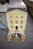 A wooden Doll's House in the Georgian style, three storey with walk up front, height 112cm, depth