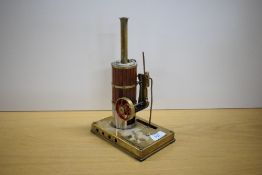 A Brass live steam model of a vertical cylinder engine, height 15cm, diameter of flywheel 6.5cm