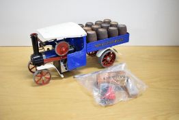 A Mamod SW1 Live Steam Wagon with 12 wooden barrels present, blue, and white, with accessory pack,