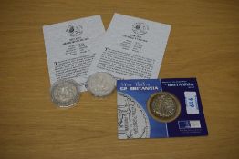 Three GB Silver Coins, 2001 Britannia on card, George V 1935 and 1937 Crowns in plastic capsules