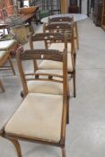 A set of four Regency mahogany railback dining chairs having later upholstered drop in seats
