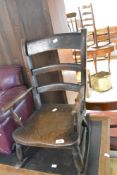 A traditional stained frame childs rocking chair, width approx. 33cm