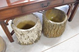 A pair of concrete garden plants, modelled as log stumps