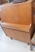 A vintage teak bureau, having compartmented interior, single drawer and double cupboards, width