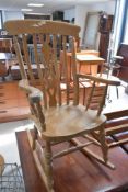 A light stained rocking chair of traditional design