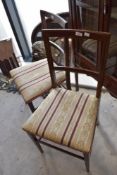 A pair of Edwardian mahogany bedroom chairs having line inlay decoration