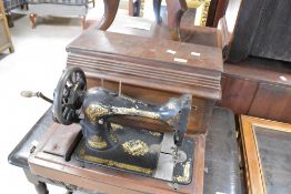 A 19th Century Singer sewing machine (hand crank) in mahogany case