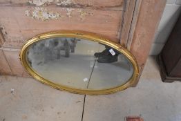 A vintage gilt frame oval wall mirror