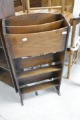 A vintage stained frame paper rack, with two trough style book shelves under, height approx. 87cm
