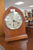 An early 20th Century mahogany cased mantel clock having silvered dial with Arabic numerals,