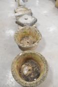 A large collection of concrete garden planters and ornaments