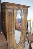 An early 20th Century oak mirror door wardrobe, dimensions approx. H186 W100cm