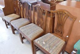 A set of four Georgian mahogany Hepplewhite style chairs having upholstered drop in seats