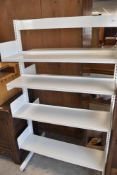 A set of free standing powder coated metal library shelves , width approx. 93cm