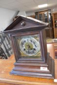 A 19th Century oak cased mantel clock of architectural form with brass and silvered dial, worn
