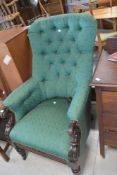 A Victorian easy chair having scroll frame and later button back upholstery