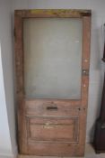 An antique stripped door , having frosted glass panel , approx. 214 x 101cm