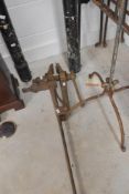 A vintage leg vice and wrought iron candle stand