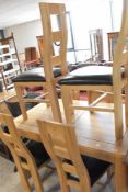 A modern oak (oak furniture land) extending dining table and six chairs, approx. 130 x 80cm (plus