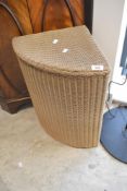A vintage Lloyd Loom corner linen basket