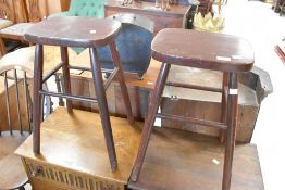 A pair of traditional dark stained bar stool on turned frame