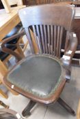 An early 20th Century oak swivel armchair