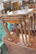 A walnut nest of three tables having cabriole legs