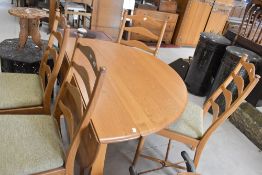 A modern Ercol, Sutherland narrow style gate leg dining table and set of four ladder back dining