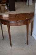A 19th Century mahogany fold over demi lune tea table