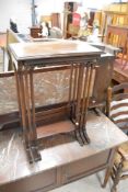 An Edwardian mahogany nest of three occasional tables, having gadrooned edge and turned column