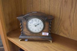 A small oak cased mantel clock having enamelled dial named for Walker & Hall, French made, width