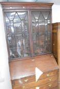 A Georgian and later mahogany bureau having matched astral glazed bookcase over