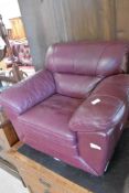 A modern/vintage burgundy leather childs armchair, width approx. 57cm, DV motif to side