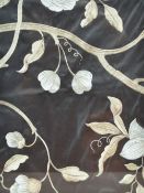 A pair of decorative embroidered Indian silk panels, depicting blossoms against an light blue and