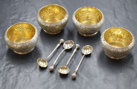 A cased set of four Victorian silver salts and condiment spoons, of circular form having Eastern