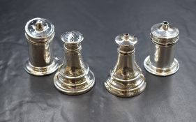 A pair of George V silver salt and pepperette, of cylindrical form with step moulding and blue glass