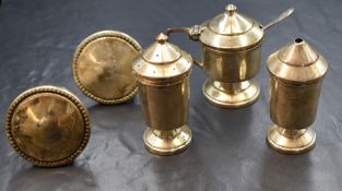 A cased George V silver condiment set, comprising salt, pepper and mustard with spoon, of