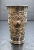 A late 19th/early 20th century silver vase, of cylindrical form having embossed scroll decoration
