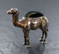 An Edwardian silver novelty pin cushion, modelled as a camel having dark fabric to the body, marks