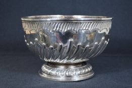 A large Victorian silver punch bowl, of circular form having a moulded rim and half gadrooned